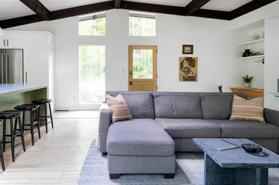 a living room with a couch and a table at Private Cabin by River with Fireplace in Phoenicia