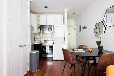 a kitchen and dining room with a table and chairs at 24-10 Studio in Prime Gramercy WD in Unit in New York