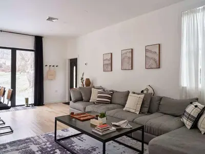 a living room with a couch and a table at Chic Renovated Chalet with Private Pond in Roscoe