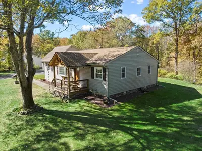 a small house in a yard with a tree at Cozy Home with Game Room and Fire Pit in New Paltz