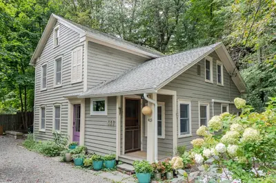a small gray house with plants in front of it at Chic Farmhouse Woodstock Saugerties Skiing HITS in Saugerties