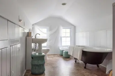 a bathroom with a bath tub and a sink at Chic Farmhouse Woodstock Saugerties Skiing HITS in Saugerties