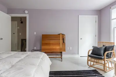 a bedroom with a bed and a chair and a dresser at Chic Farmhouse Woodstock Saugerties Skiing HITS in Saugerties