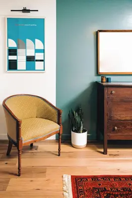 a living room with a chair and a tv at The Perch Hotel in East Windham