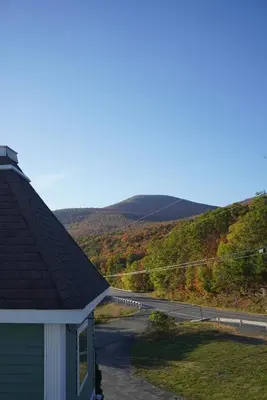 a house with a view of a road and mountains at The Perch Hotel in East Windham