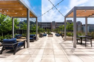 a patio with tables and chairs on a building at Luxury 2 BR Apt with Gym in Stamford