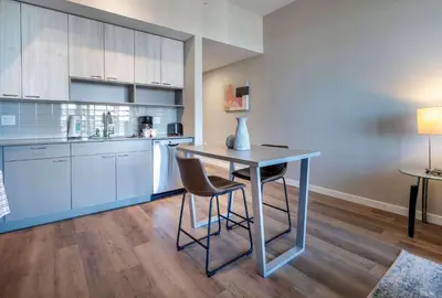a kitchen with a table and chairs in a room at Spacious Harbor Apt with Balcony in South End