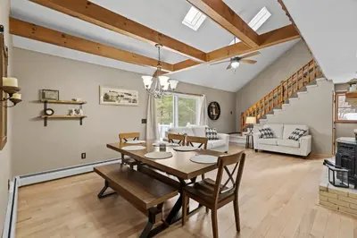 a dining room and living room with a table and chairs at 3BR Lake Luzerne Retreat with Game Room & Cozy Fire Pit in Lake Luzerne