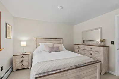 a bedroom with a bed with a mirror and a dresser at 3BR Lake Luzerne Retreat with Game Room & Cozy Fire Pit in Lake Luzerne