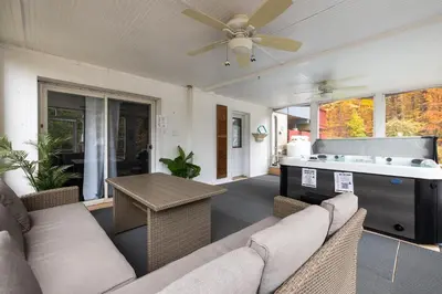 a living room with a couch and a table at 3BR Lake Luzerne Retreat with Game Room & Cozy Fire Pit in Lake Luzerne