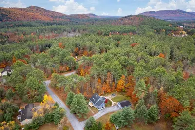 an aerial view of a house in the forest at 3BR Lake Luzerne Retreat with Game Room & Cozy Fire Pit in Lake Luzerne