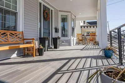 a porch with a wooden bench on a house at Modern 3 Bed Apt Parking W D in Schenectady