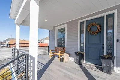 a front porch with a blue door and a bench at Modern 3 Bed Apt Parking W D in Schenectady