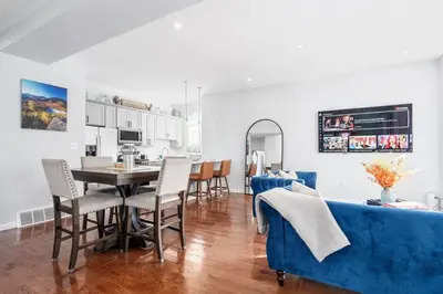 a kitchen and dining room with a table and chairs at Modern 3 Bed Apt Parking W D in Schenectady