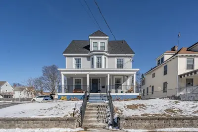 a white house with snow on the steps at Modern 3 Bed Apt Parking W D in Schenectady