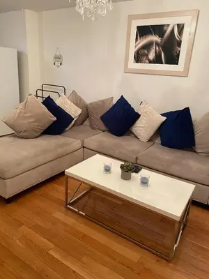 a living room with a couch and a coffee table at Prime Murray Hill 2 BR Gem in New York