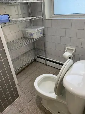a bathroom with a toilet and a sink at Prime Murray Hill 2 BR Gem in New York