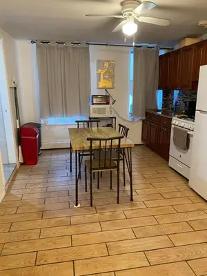 a kitchen with a table and chairs in it at Prime Murray Hill 2 BR Gem in New York