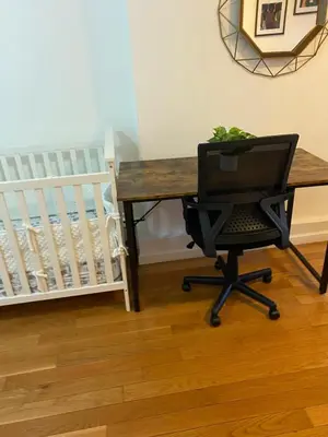 a desk with a chair with a computer on it at Prime Murray Hill 2 BR Gem in New York