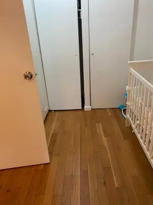 an empty room with a door and a wooden floor at Prime Murray Hill 2 BR Gem in New York