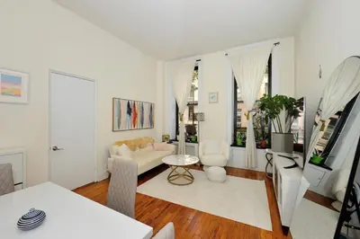 a white living room with a couch and a table at Prime Murray Hill 1BR - Near Grand Central in New York