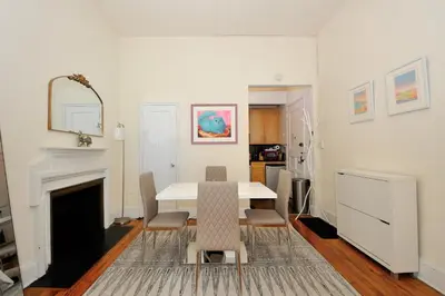 a dining room with a white table and chairs at Prime Murray Hill 1BR - Near Grand Central in New York