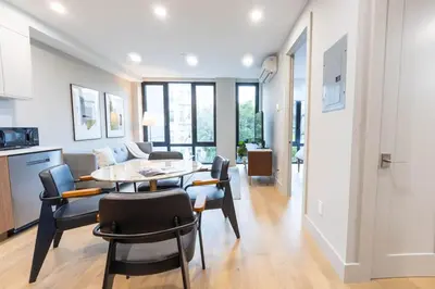 a kitchen and dining room with a table and chairs at 149BK-301 New Construction 1BR Prime BK WD in Brooklyn