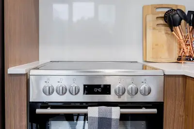 a stove top oven in a kitchen next to a counter at 149BK-301 New Construction 1BR Prime BK WD in Brooklyn