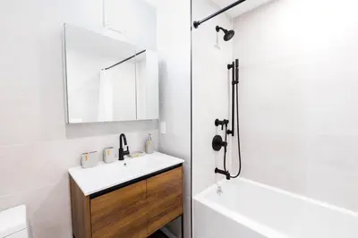 a white bathroom with a sink and a mirror at 149BK-301 New Construction 1BR Prime BK WD in Brooklyn