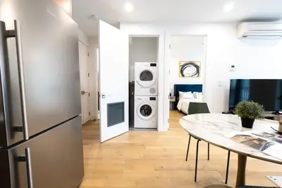 a kitchen and living room with a refrigerator and a table at 149BK-302 New Construction 1BR WD in unit Balcony in Brooklyn