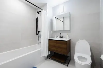 a white bathroom with a toilet and a sink at 149BK-302 New Construction 1BR WD in unit Balcony in Brooklyn