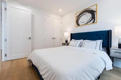 a bedroom with a large bed with a blue headboard at 149BK-302 New Construction 1BR WD in unit Balcony in Brooklyn