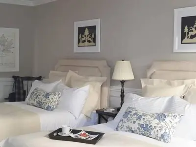 a bedroom with two beds and a tray of food on the bed at The White Hart in Salisbury