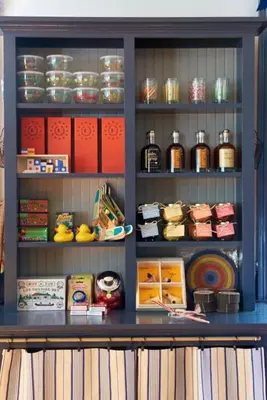 a shelf filled with lots of different types of food at The White Hart in Salisbury