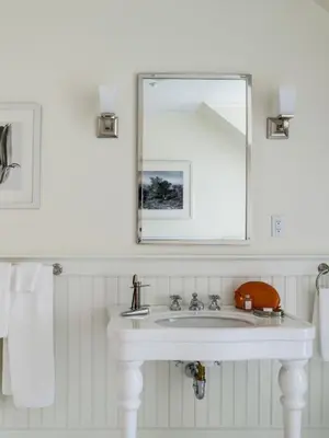 a bathroom with a white sink and a mirror at The White Hart in Salisbury