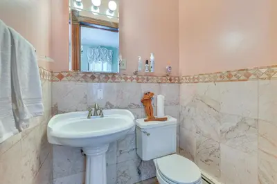 a bathroom with a sink and a toilet and a mirror at 5 Mi to Belleayre Lake Getaway in Fleischmanns! in Fleischmanns