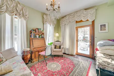 a living room with a couch and a chandelier at 5 Mi to Belleayre Lake Getaway in Fleischmanns! in Fleischmanns