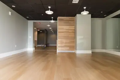 a large room with a wooden wall in the middle at Chique Loft 10 Min from NYC with Gym, Pool & Sauna in Jersey City