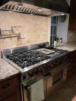 a kitchen with a stainless steel stove top oven at The Historic Jesse Buel Farmhouse w Heated Pool in Albany