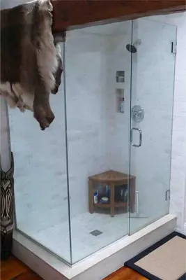 a shower with a glass enclosure in a room at The Historic Jesse Buel Farmhouse w Heated Pool in Albany