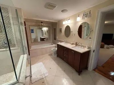 a bathroom with a shower and a sink and a toilet at The Historic Jesse Buel Farmhouse w Heated Pool in Albany