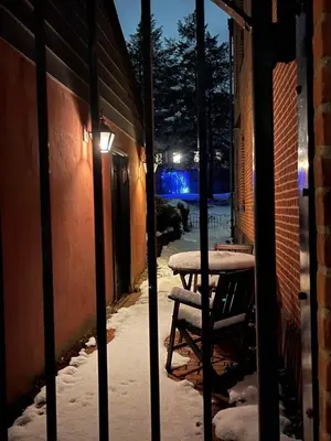 a table and chairs on a street at night at The Historic Jesse Buel Farmhouse w Heated Pool in Albany