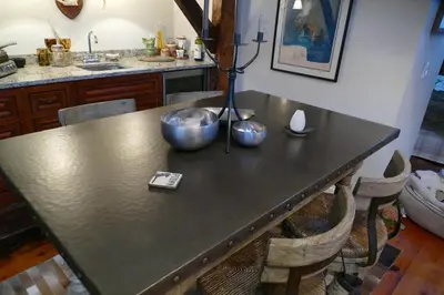a kitchen with a table with two bowls on it at The Historic Jesse Buel Farmhouse w Heated Pool in Albany