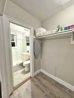a bathroom with a toilet and a sink and a mirror at Yale Casa Rosa Studio in New Haven