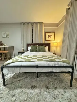a bedroom with a large bed in a room at Yale Casa Rosa Studio in New Haven