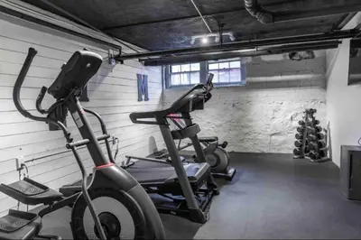 a gym with two exercise bikes in a room at Yale Casa Rosa Studio in New Haven
