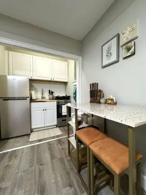 a kitchen with a counter and a refrigerator at Yale Casa Rosa Studio in New Haven