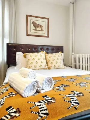 a bed with towels and pillows on top of it at Chateau Blanc Yale Located Downtown in New Haven