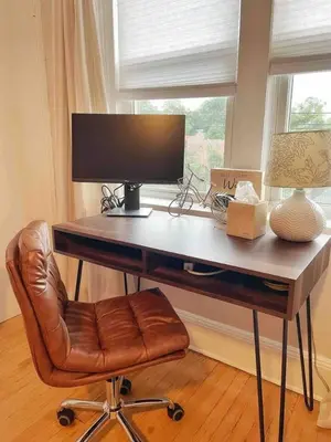a desk with a computer monitor and a chair at Chateau Blanc Yale Located Downtown in New Haven