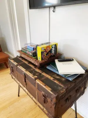 an old trunk with books and books on top of it at Chateau Blanc Yale Located Downtown in New Haven